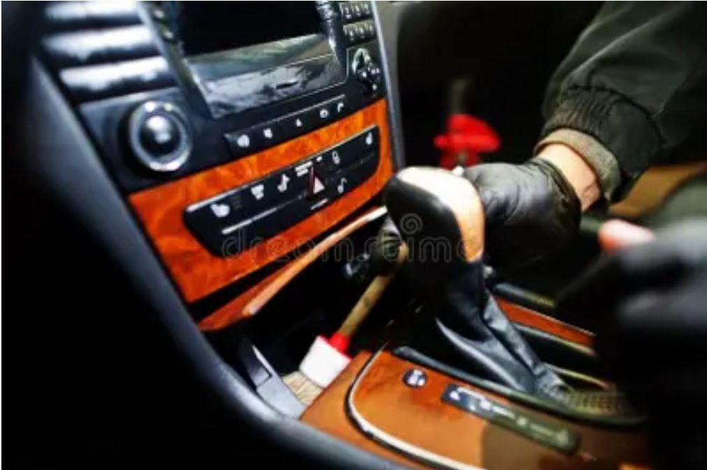 Man detailing interior with a brush 